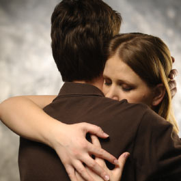 Man Hugging Sad Woman